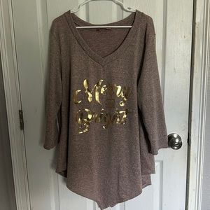 Woman’s Christmas blouse. It says “Merry & Bright”.